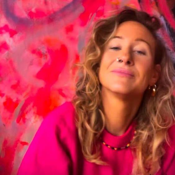 Woman with long blonde hair against a colorful abstract background