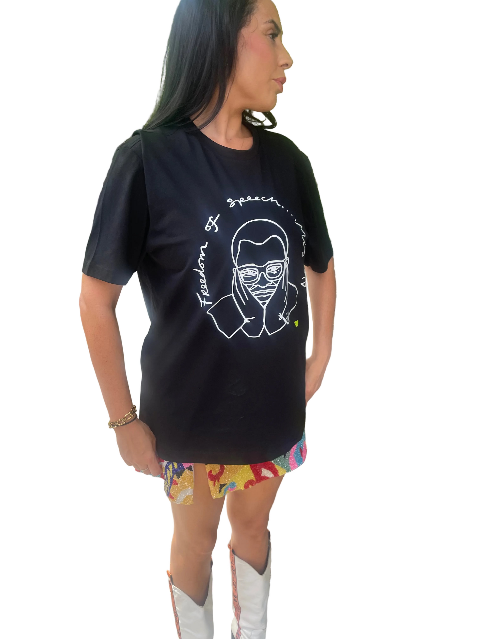 Person wearing a black t-shirt with a graphic design outdoors
